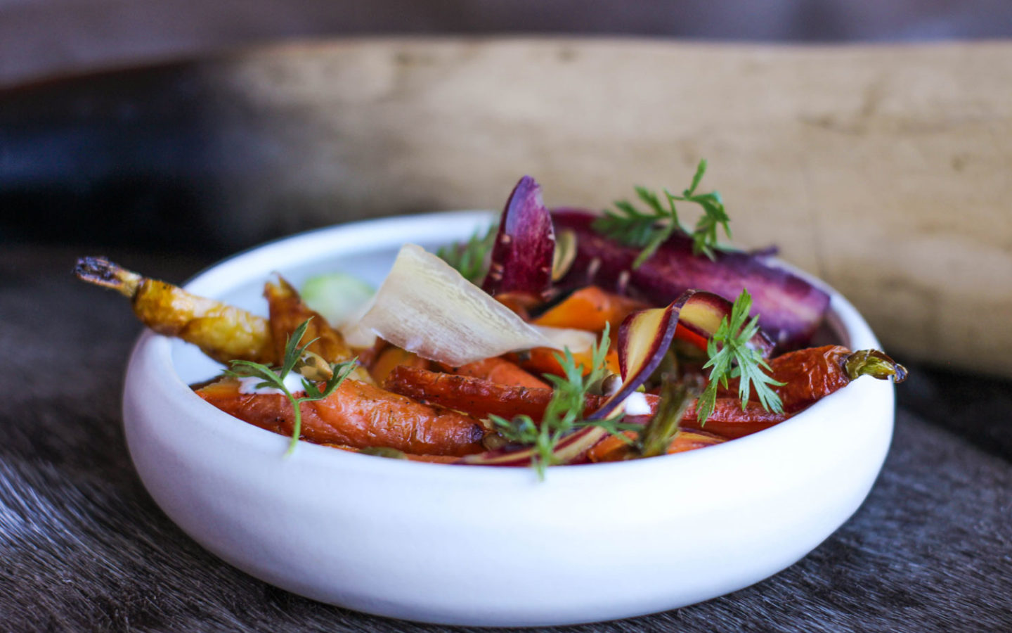 garnished carrot dish in white low rimmed bowl