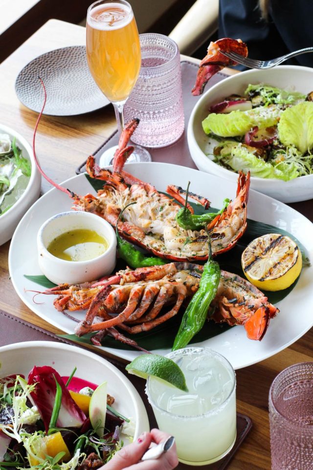 large lobster dish on table of two seated guests ready to eat